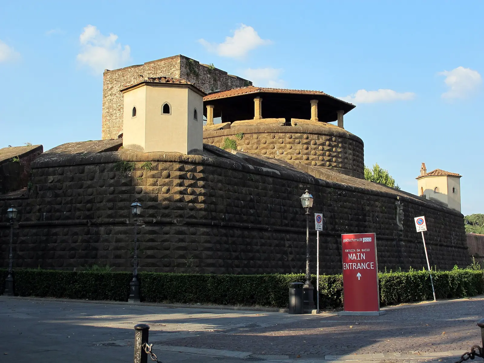 The brick bastions of the Fortezza da Basso in Florence with the main entrance sign