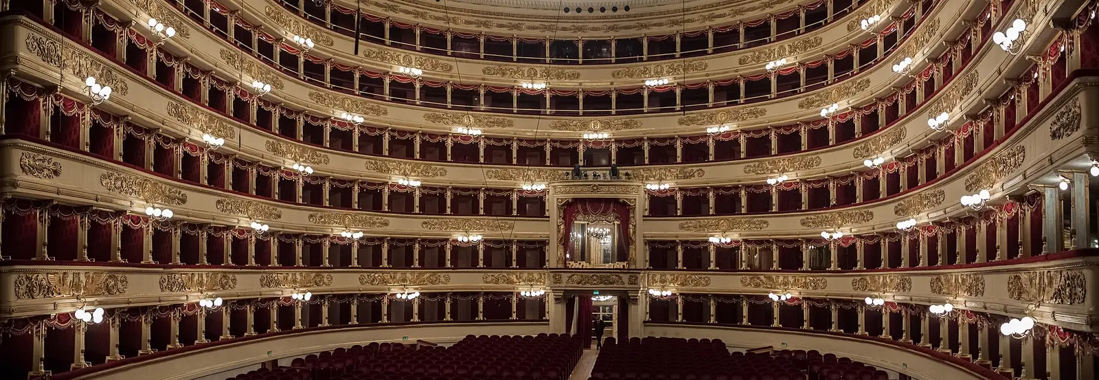 The tiers of boxes and red stalls of Teatro alla Scala seen from the stage