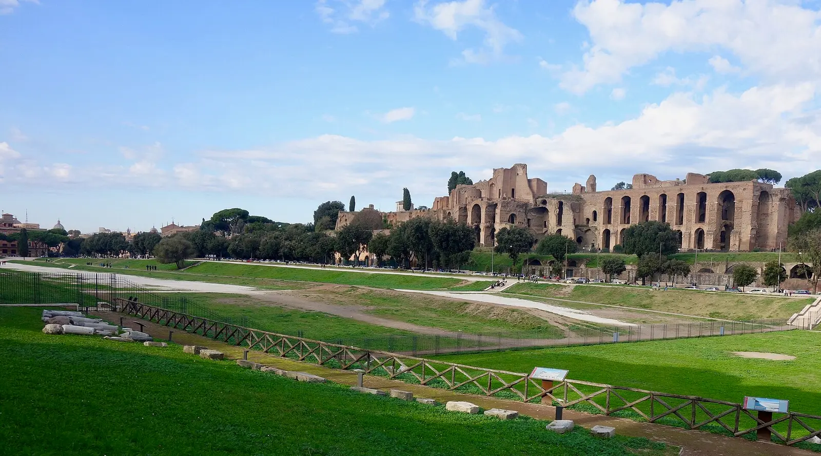 The open grass valley of the Circo Massimo in Rome with the Palatine ruins behind